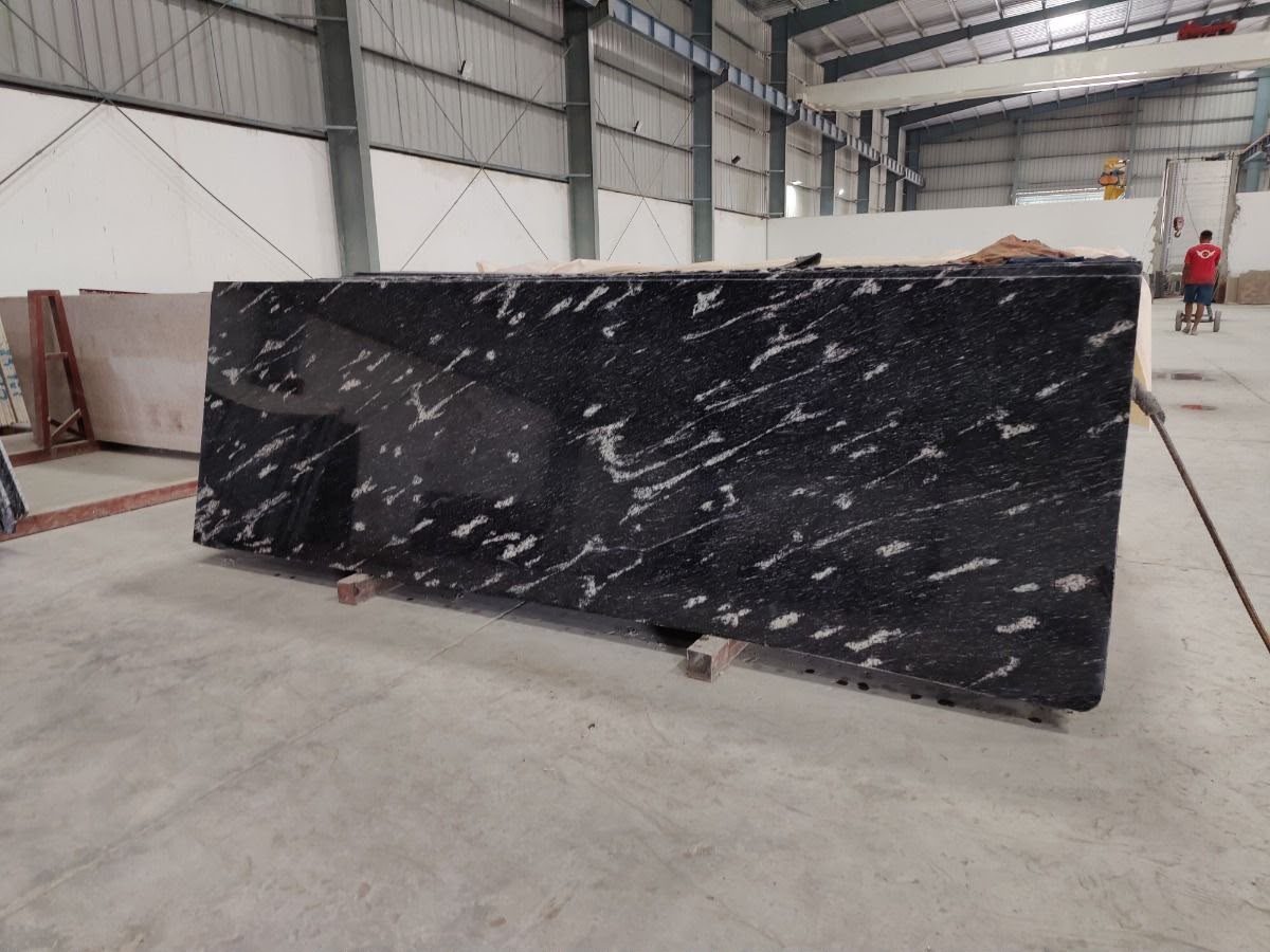 Black granite slab with bold white veins in our slab yard