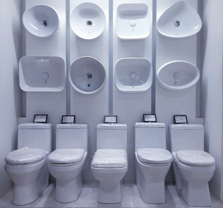 Row of wall-hung basins above one-piece WCs