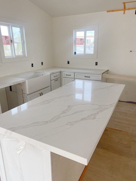 Bright kitchen with a white marble-look island