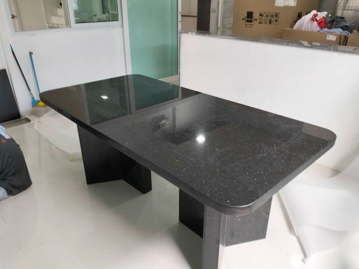 Polished black granite dining table with stone pedestal base